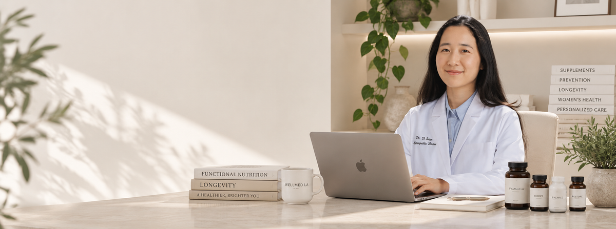 Dr. Shin, naturopathic doctor, at her desk with Wellmed LA supplements